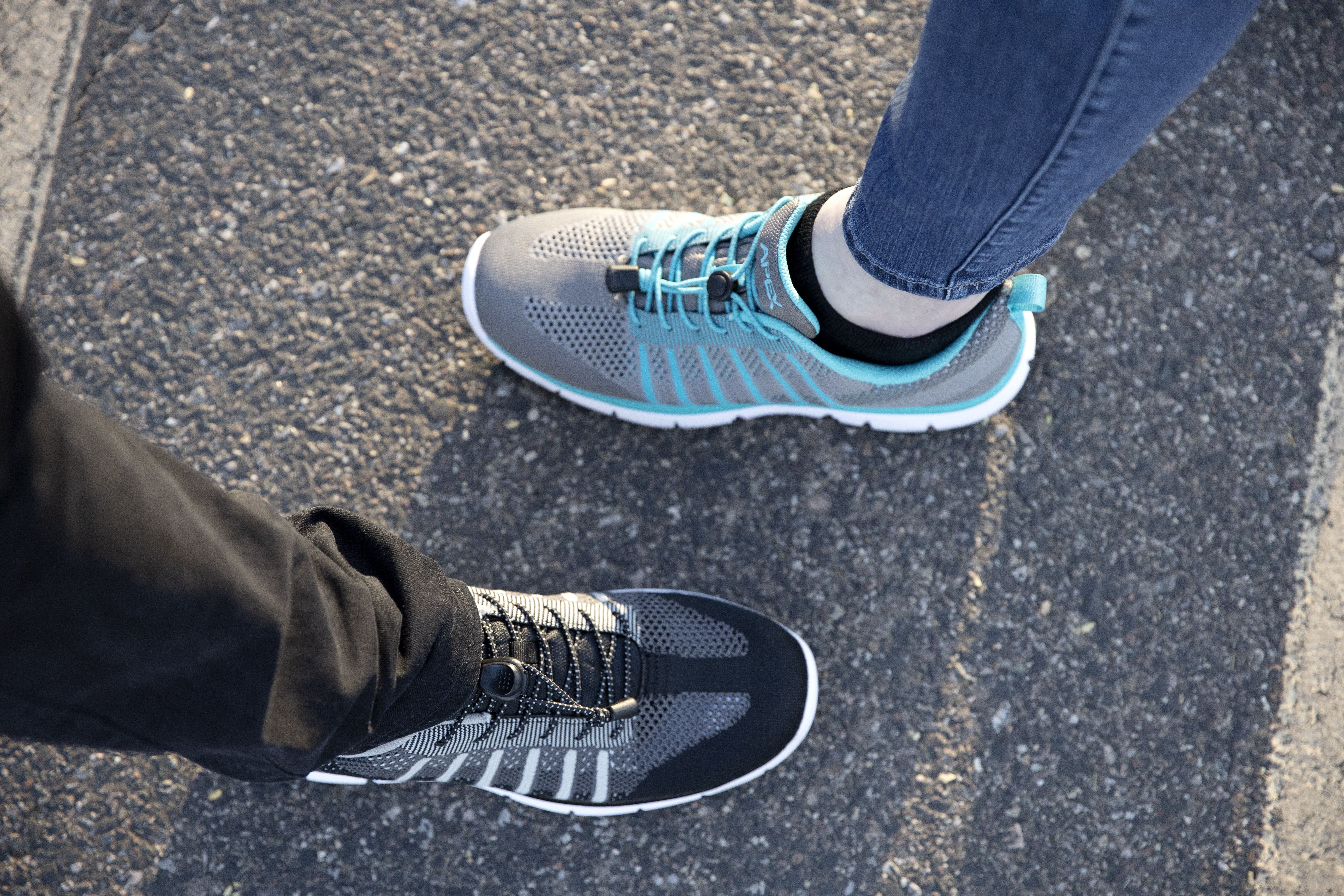 Close up of couple wearing Apex Men's Knit Active Shoe Bolt - Black and Apex Women's Knit Active Shoe Breeze - Grey Close up of couple wearing Apex Men's Knit Active Shoe Bolt - Black and Apex Women's Knit Active Shoe Breeze - Grey
