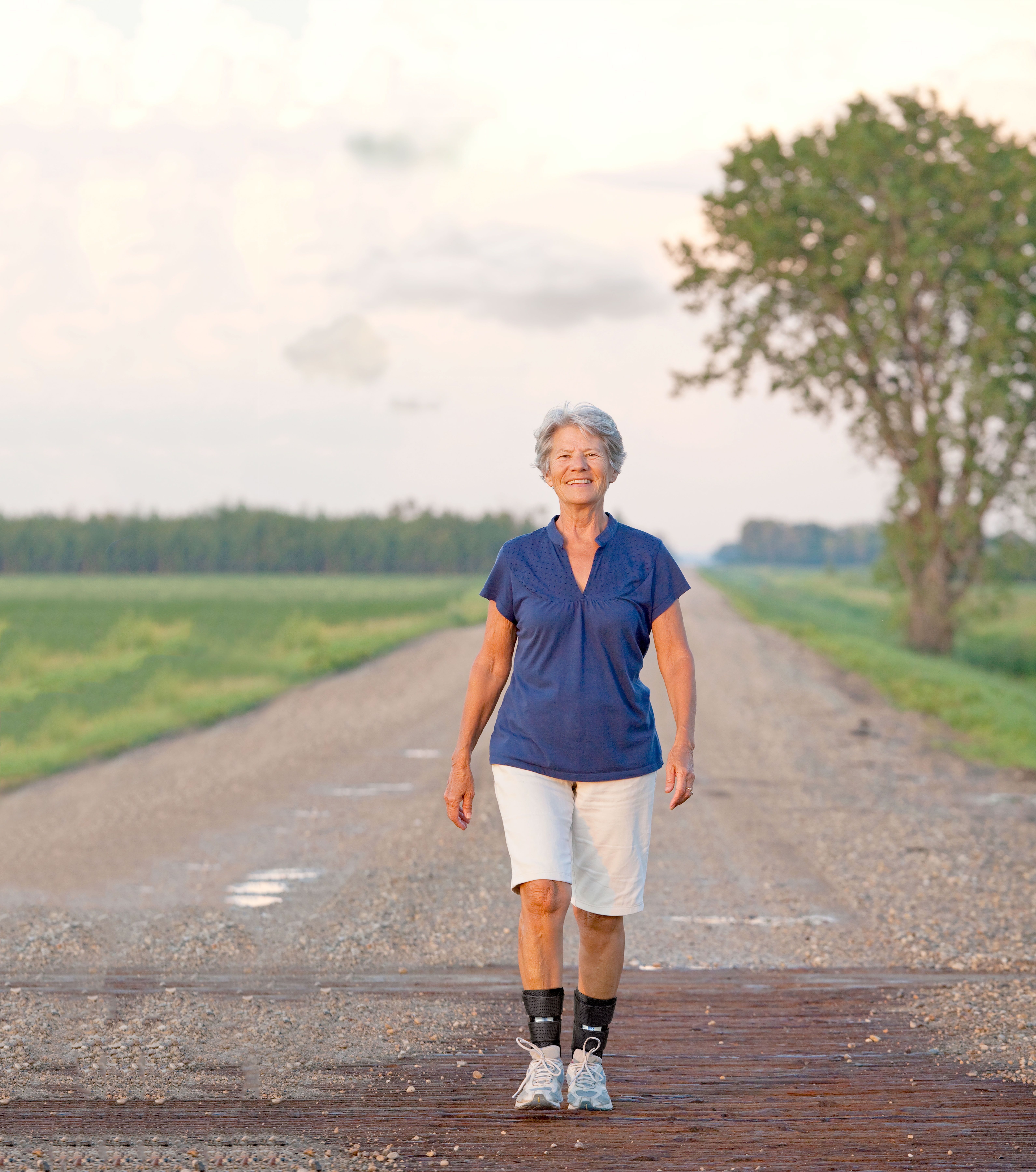 Woman walking down street wearing Women's Boss Runner Active Shoe - X-Last - Silver/Sea Blue Woman walking down street wearing Women's Boss Runner Active Shoe - X-Last - Silver/Sea Blue