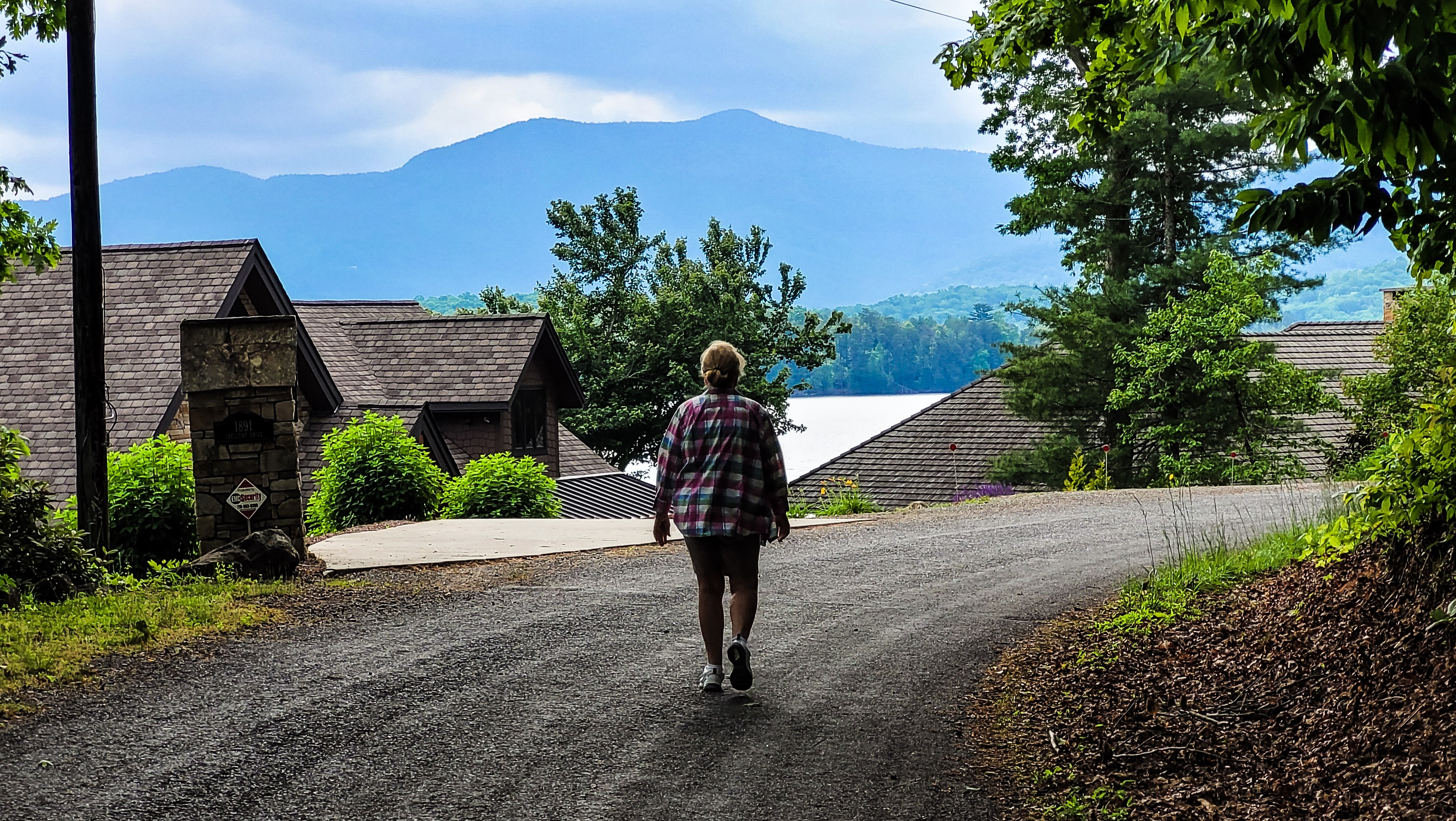 Woman Walking Along Twisting Road Woman Walking Along Twisting Road