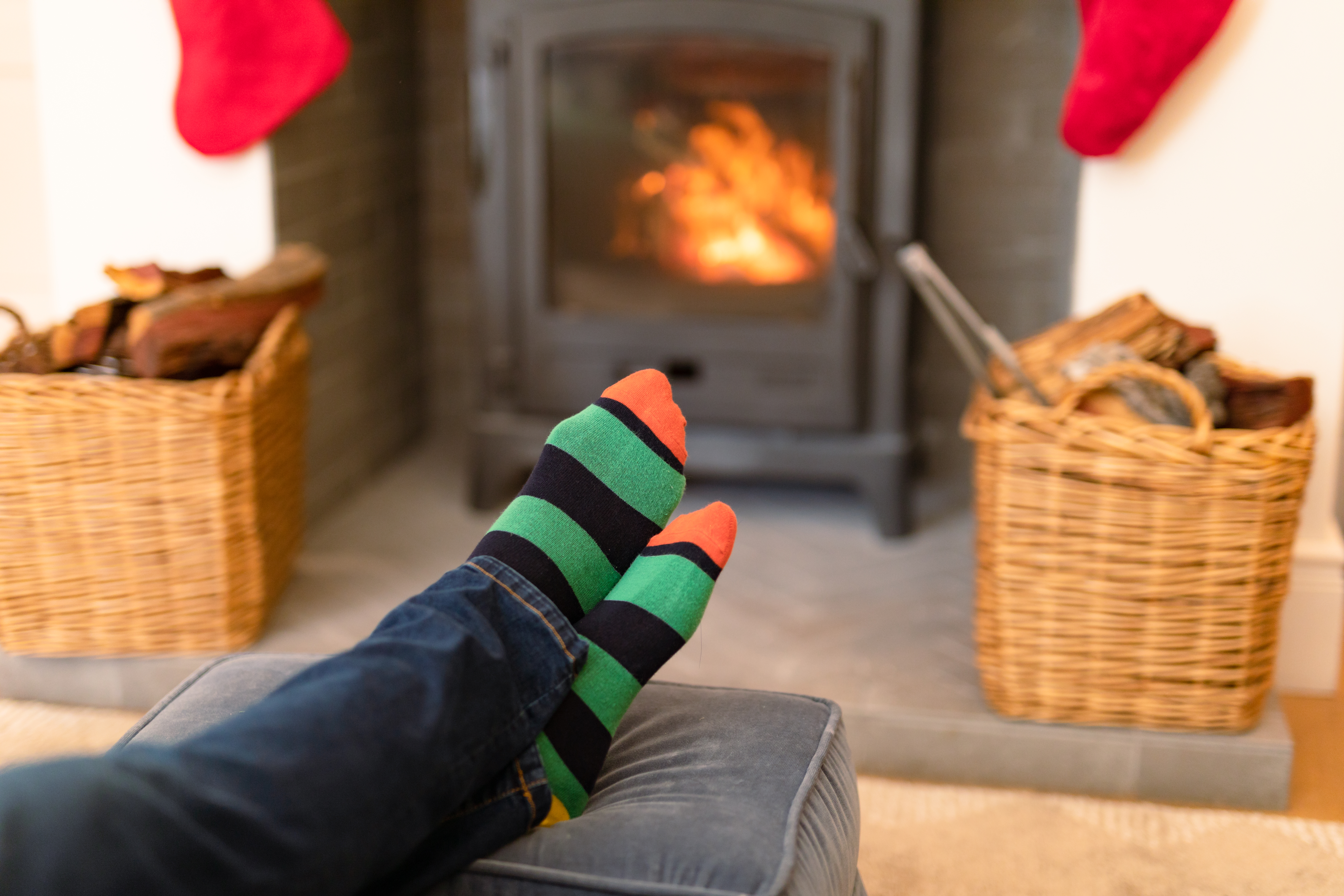 feet of man wearing Christmas socks and resting feet of man wearing Christmas socks and resting