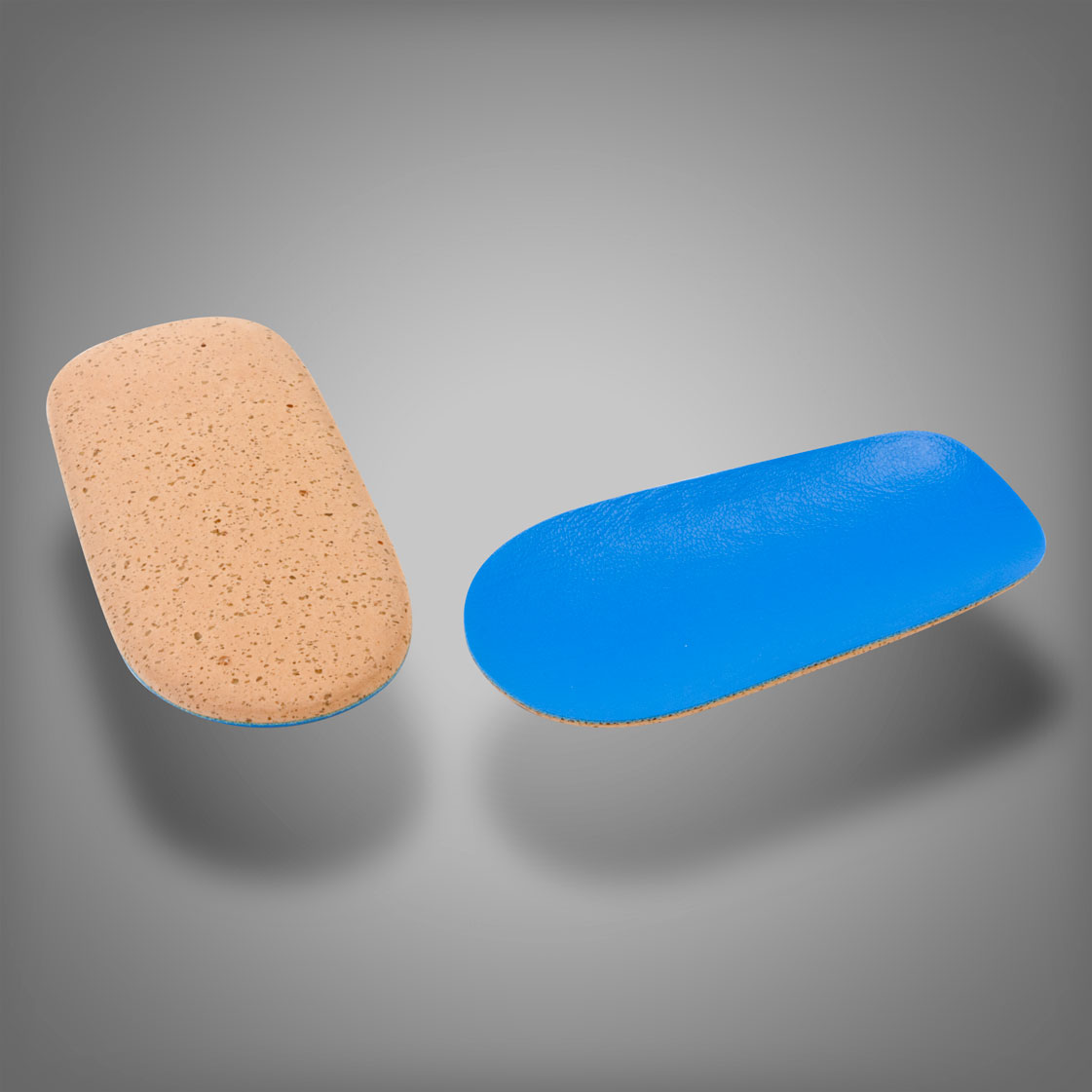 Close up of cork heel lift and foam rubber lift Close up of cork heel lift and foam rubber lift