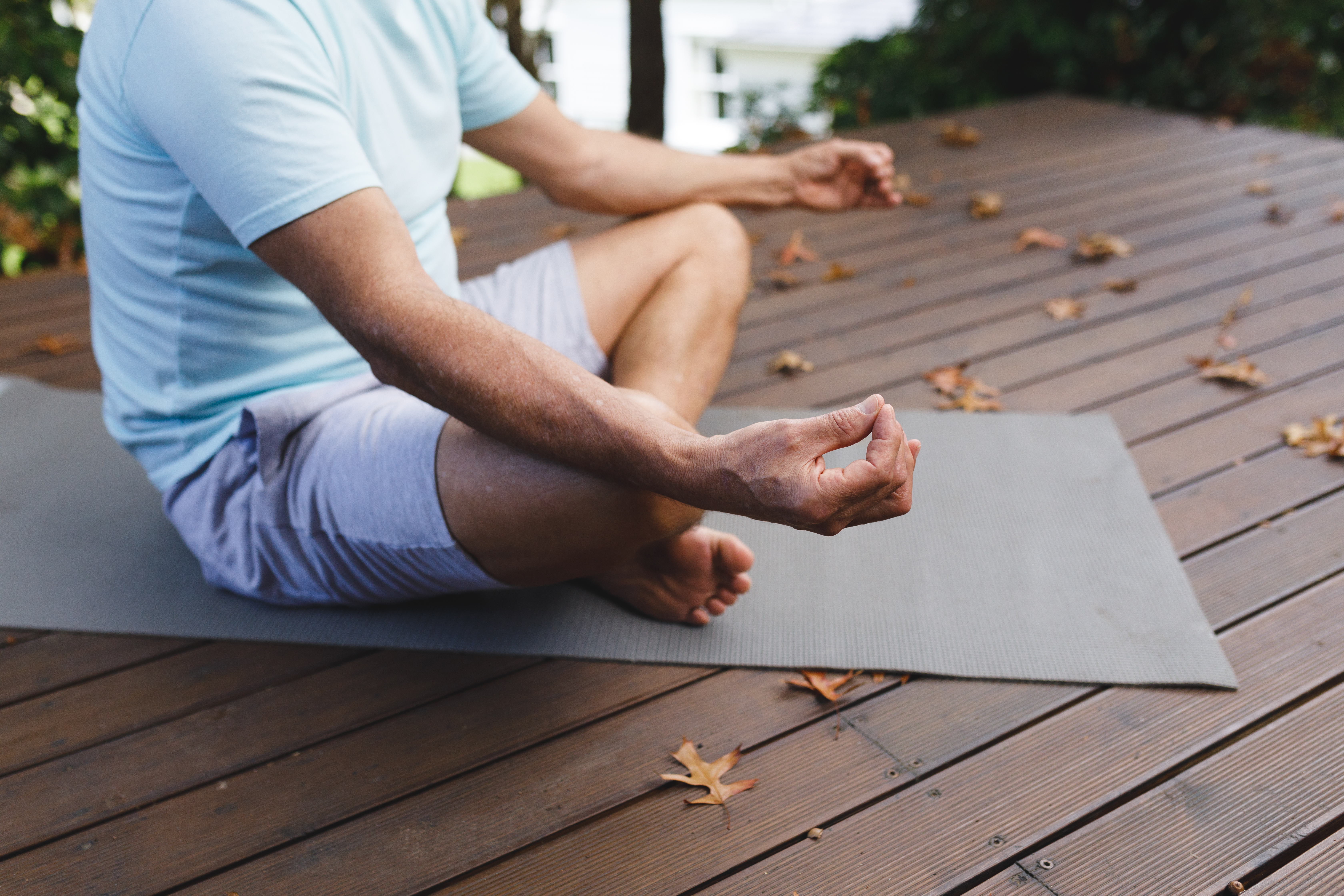 Man Doing Yoga on Outdoor Patio Man Doing Yoga on Outdoor Patio