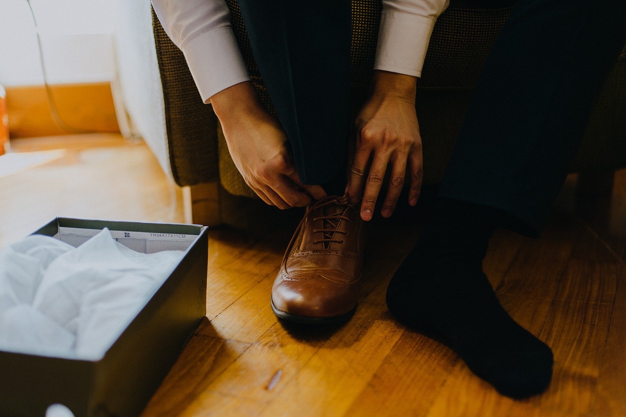 Man trying on dress shoes that are too small Man trying on dress shoes that are too small